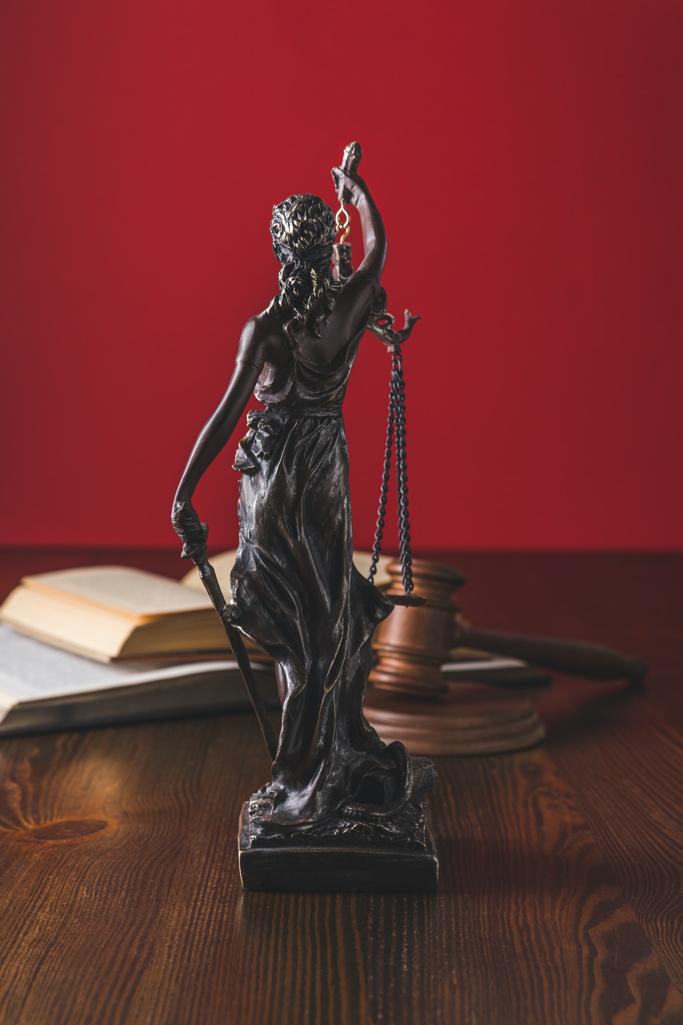 opened-juridical-books-with-lady-justice-statue-on-wooden-table-law-concept.jpg